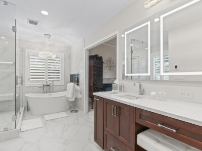 01-DSC04364 Modern bathroom featuring a freestanding tub, glass shower, dual vanities with mirrors, and elegant marble flooring, showcasing a stylish and functional design for remodeling inspiration.