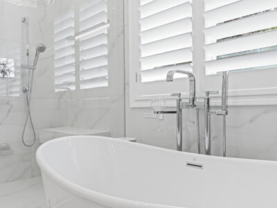 10-DSC04312 Modern bathroom featuring a freestanding white tub, sleek chrome fixtures, and marble accents, highlighting luxury design elements for remodeling projects.