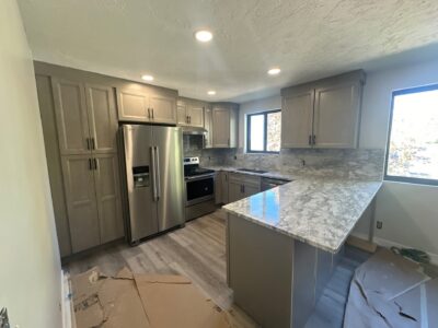 14-Nov 11 2024 08_08pm-okf1 Modern kitchen with gray cabinetry, stainless steel appliances, and a marble countertop, showcasing a bright and airy design suitable for remodeling projects.