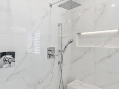 15-DSC04306 Modern bathroom shower featuring elegant marble tiles, sleek fixtures, and a built-in niche for storage, highlighting contemporary design elements for remodeling projects.