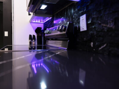 Chris10 Modern kitchen countertop with sleek design, under-cabinet lighting, and stainless steel appliances, showcasing a stylish renovation ideal for kitchen remodeling projects.