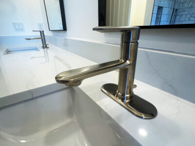 Zack8 Modern bathroom faucet on sleek white marble countertop, highlighting contemporary design and elegance in bathroom remodeling.